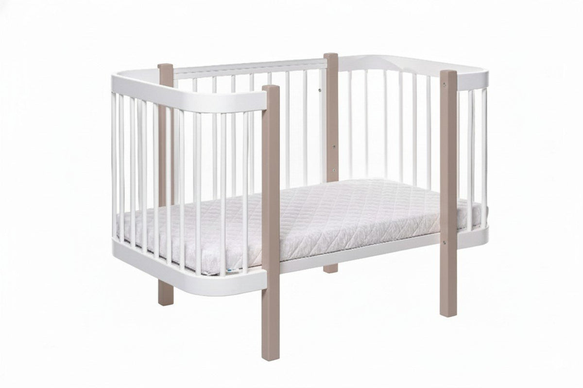 2. Studio image of KOTTO ELIN crib in cappuccino and white, highlighting slatted sides and mattress