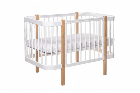 2. KOTTO ELIN baby crib in natural and white beechwood with orthopedic slatted base, shown in studio setting