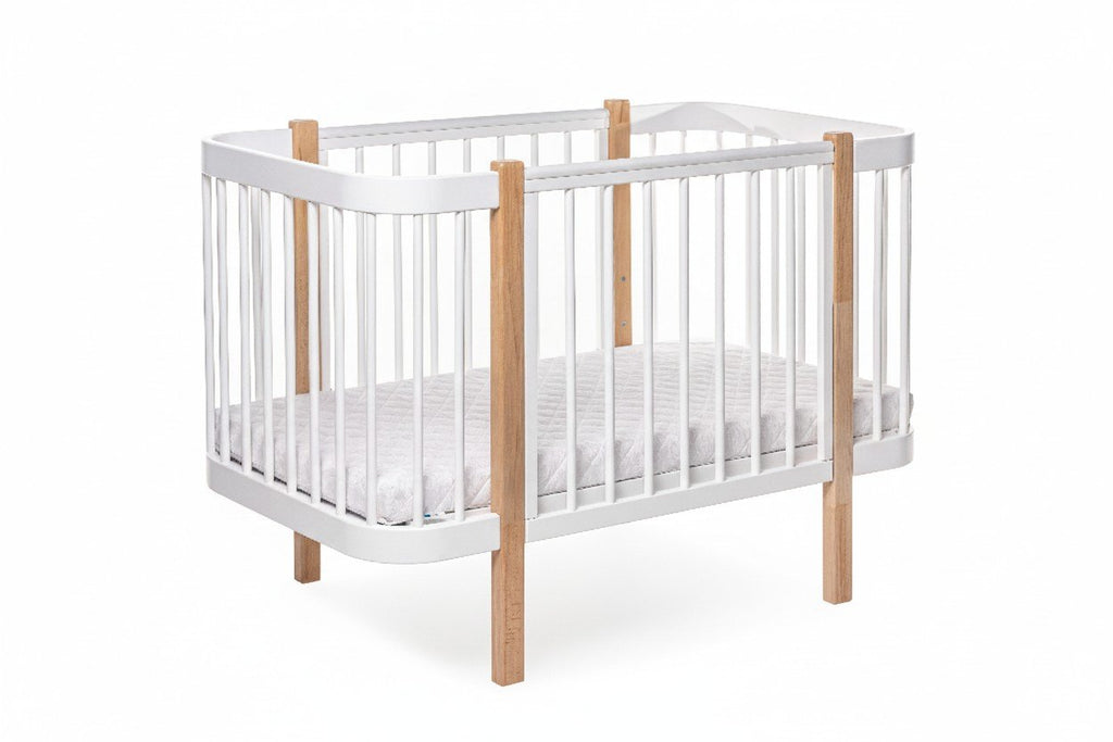 2. KOTTO ELIN baby crib in natural and white beechwood with orthopedic slatted base, shown in studio setting