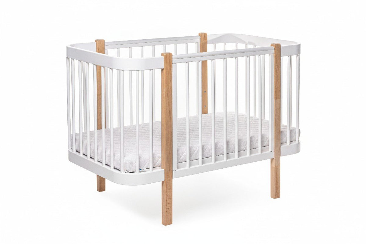 2. KOTTO ELIN baby crib in natural and white beechwood with orthopedic slatted base, shown in studio setting