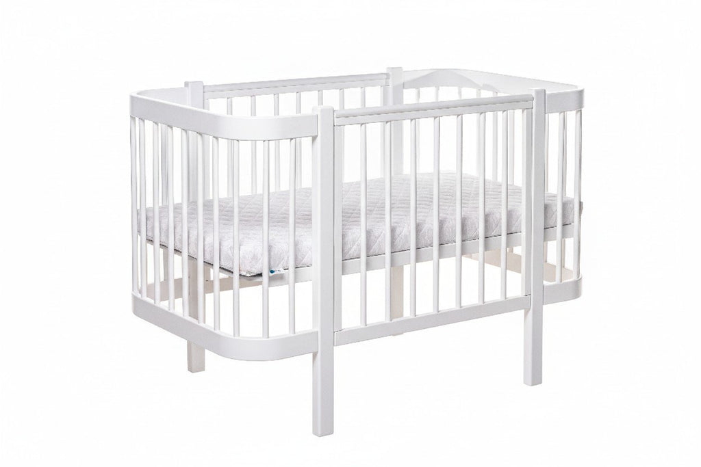 2. White ELIN baby crib with removable side panel and slatted base in studio setting