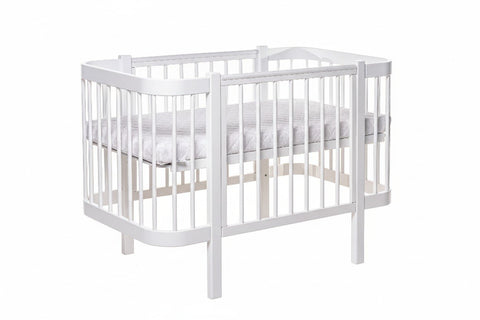 2. White KOTTO ELIN baby crib with mattress in studio setting, featuring sturdy beechwood construction