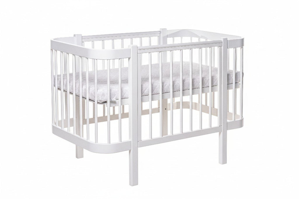 2. White ELIN baby crib made from beechwood with orthopedic slatted base shown in studio setting