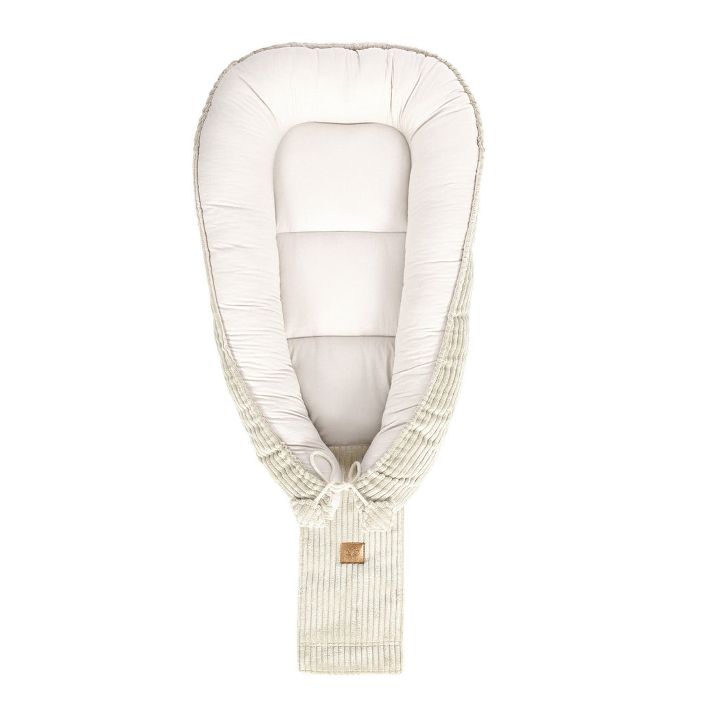 4. Ecru baby nest shown from top, featuring cushioned interior and ribbed exterior with MeowBaby logo