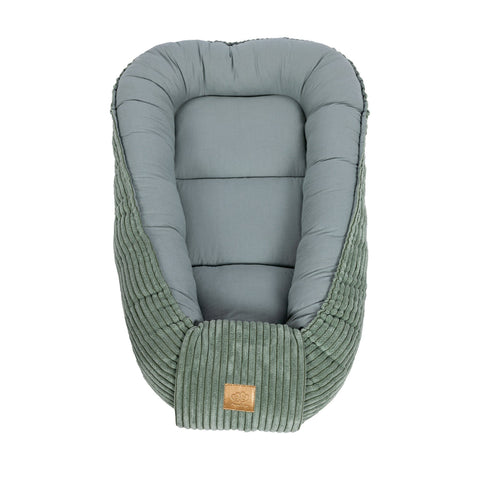 2. Olive green baby nest with ribbed fabric and cushioned interior, shown from top view