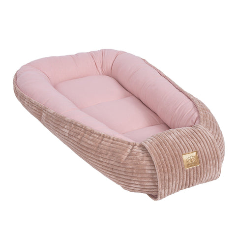 1. Powder pink baby nest with cushioned sides and ribbed texture, featuring MeowBaby logo, shown in a studio setting