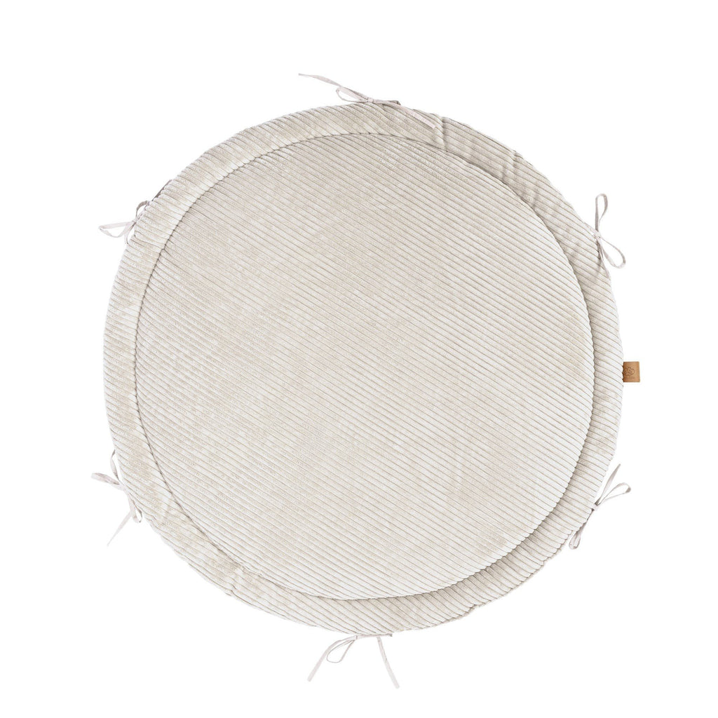 2. Ecru round play mat with ribbed texture and tie strings, shown from top view