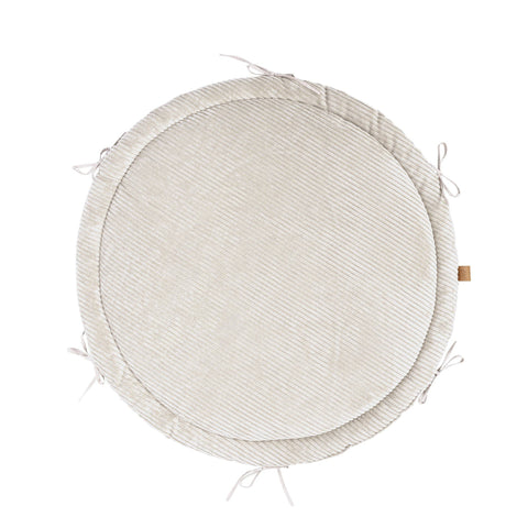 2. Ecru round play mat with ribbed texture and tie strings, shown from top view