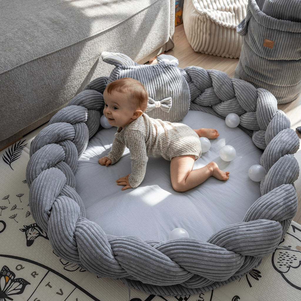 2. Infant crawling on grey braided baby nest play mat by MeowBaby, featuring soft corduroy and cotton, in a comfortable home environment