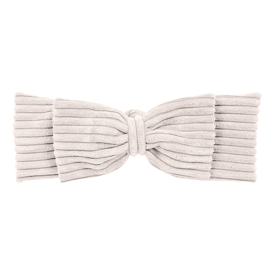 3. Close-up of ecru braided bumper in textured corduroy with bow detail