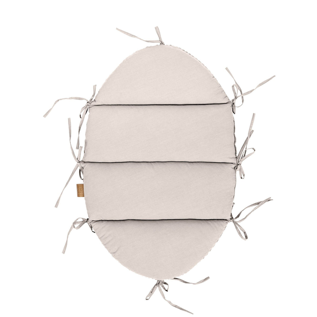 4. Flat lay of ecru baby nest mat with fabric ties, top view