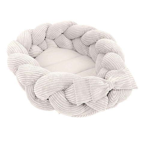 1. Ecru baby nest with braided bumper in soft corduroy, shown in a cozy oval shape
