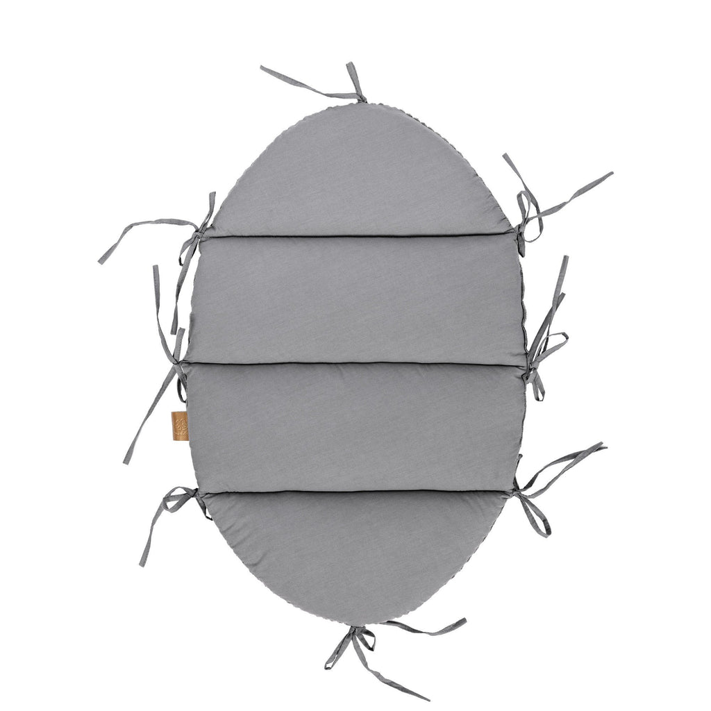 4. Flat lay of grey cotton baby mat with fabric ties, part of baby nest set