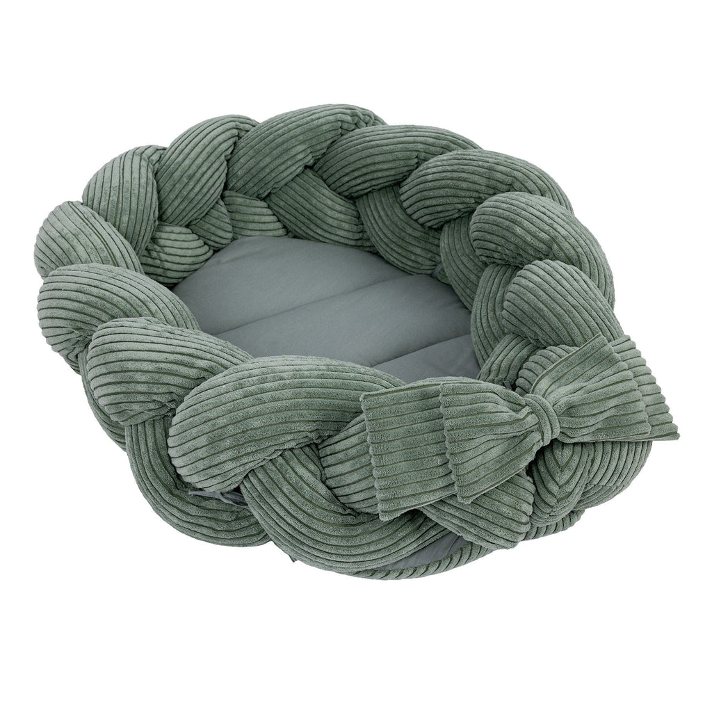1. Olive green baby nest with braided bumper made of soft corduroy, shown in a circular shape with a bow detail