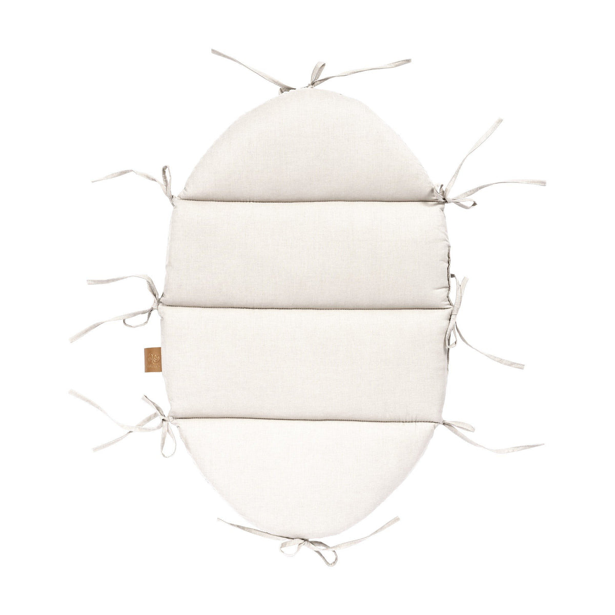 2. Flat lay of vanilla baby nest mat with fabric ties, made from 100% cotton, showing attachment points