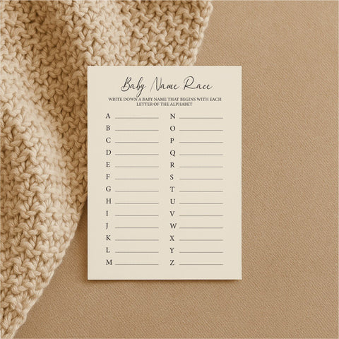 2. Single Beebila Baby Name Race game card on beige knitted fabric, featuring alphabet list for baby names on cream Munken Pure paper