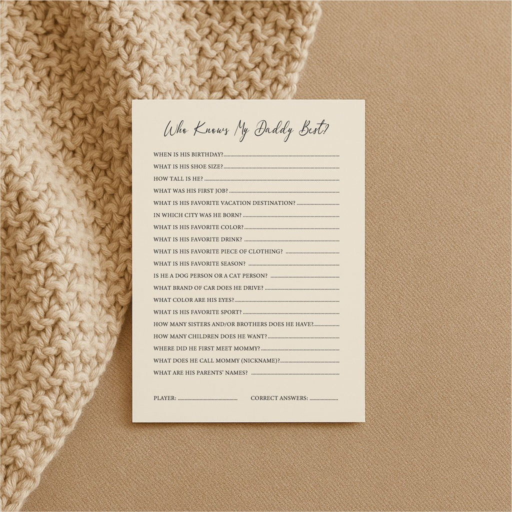 2. Single Beebila 'Who Knows Daddy Best' baby shower game card on a beige knitted blanket, showcasing questions about the dad-to-be on cream Munken Pure paper.