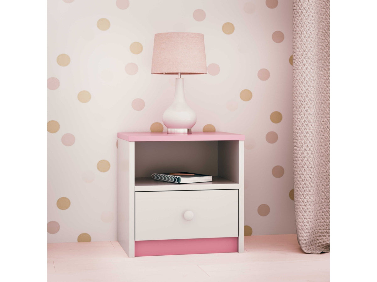 3. Pink and white bedside table with open shelf and drawer, styled with a lamp in a polka dot room