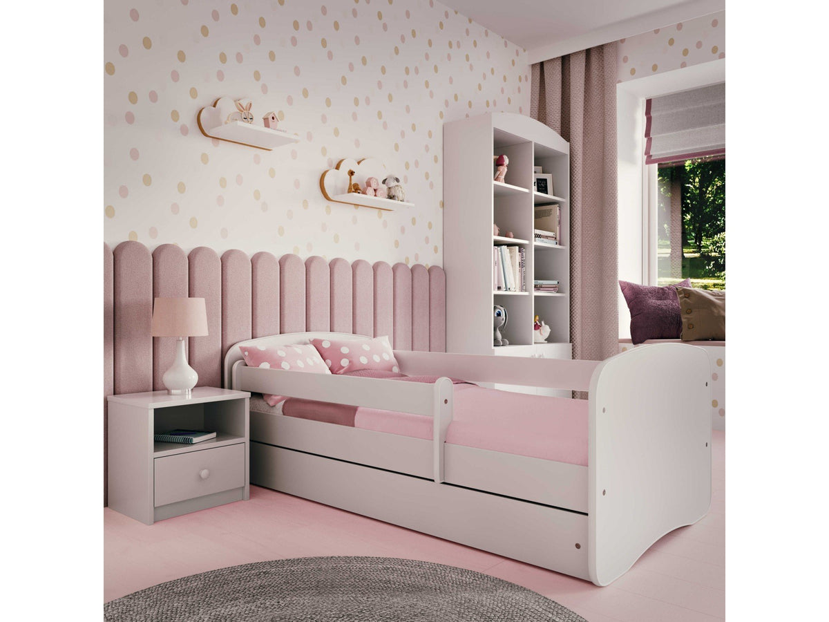 1. Pink and white children's bed in a cozy bedroom with matching decor and furniture