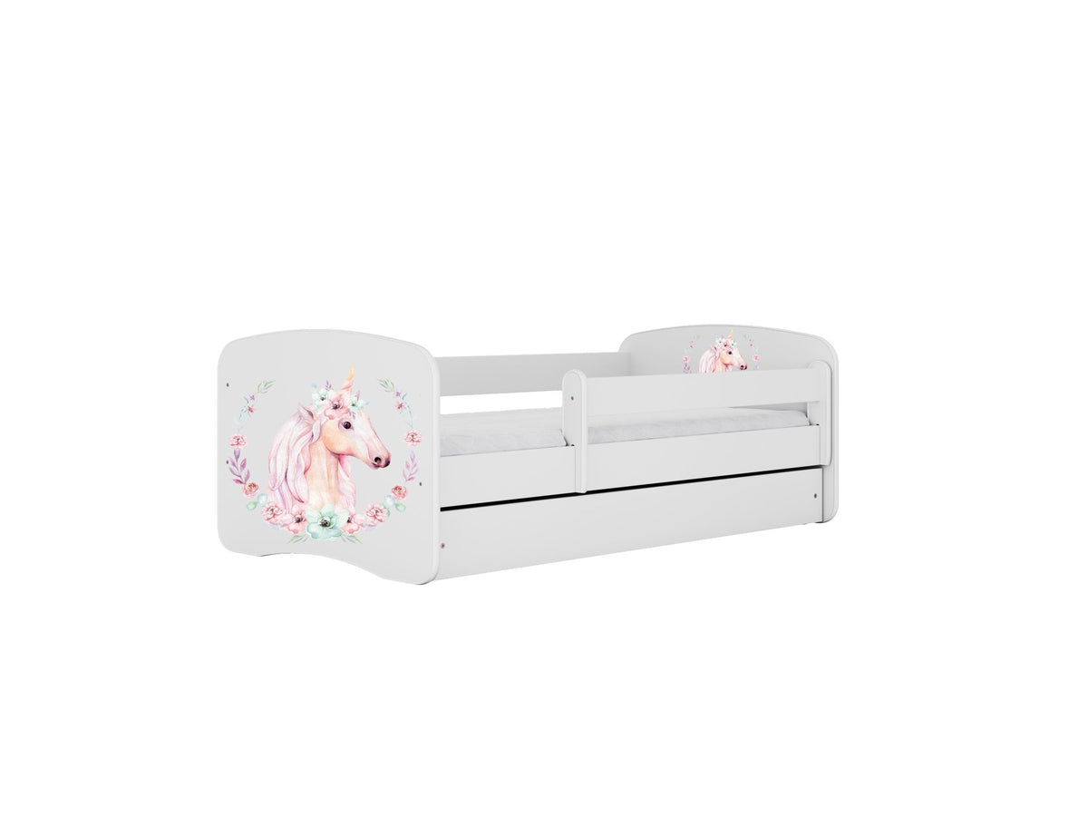 1. White children's bed with unicorn design and guardrail, featuring floral accents, shown with closed drawer