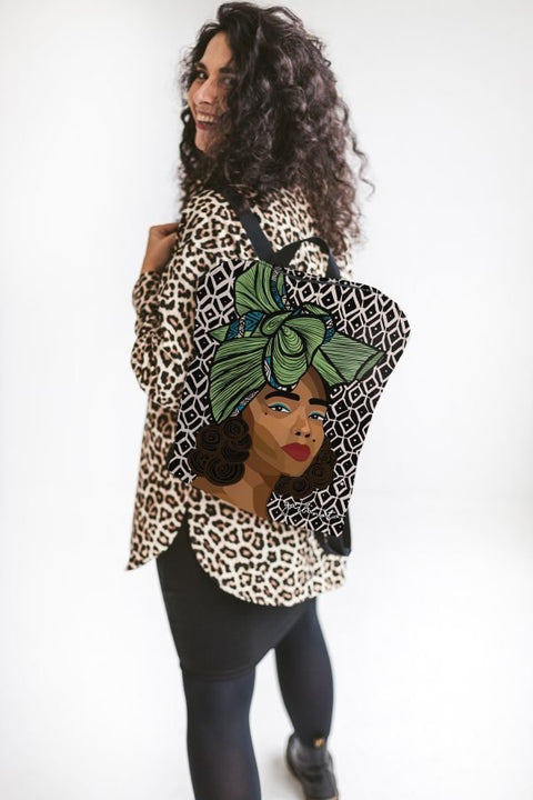 1. Woman wearing Garbanota BACKPACK TINA with Dovilė Aleksonė artwork, shown from the back in a lifestyle setting