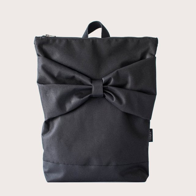 4. Front view of Muni Black Bow Large waterproof backpack, showing bow detail and sturdy polyester material