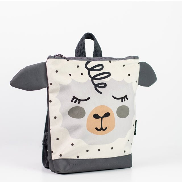 2. Studio image of Muni kids sheep backpack with velvet fabric and sheep design, shown from the front