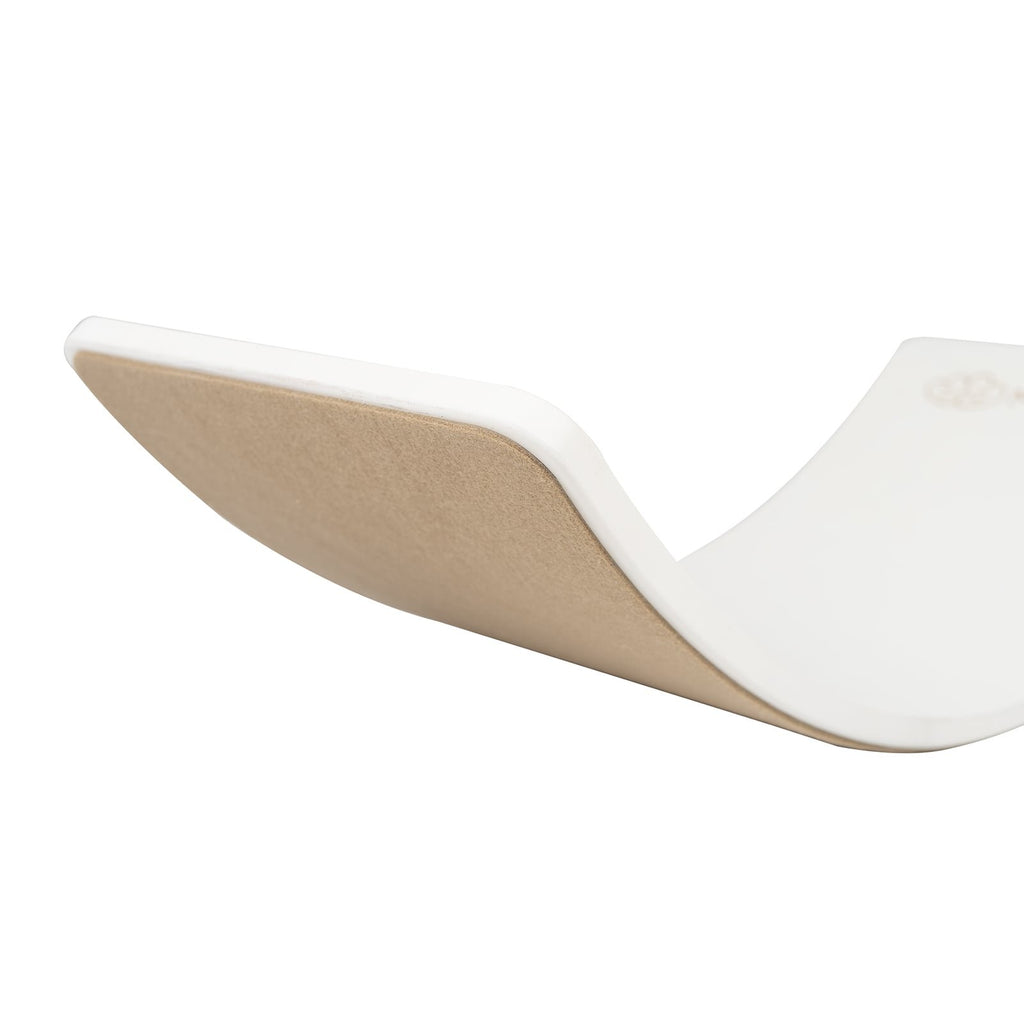 3. Close-up of white balance board with beige felt underside, highlighting curved design