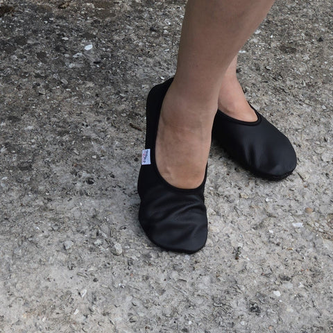 3. Black leather barefoot slippers by Hip-Hop worn outdoors on concrete