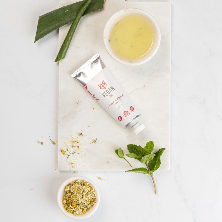 3. Flat lay of Vegan Fox Nourishing Foot Cream with natural ingredients like aloe and chamomile