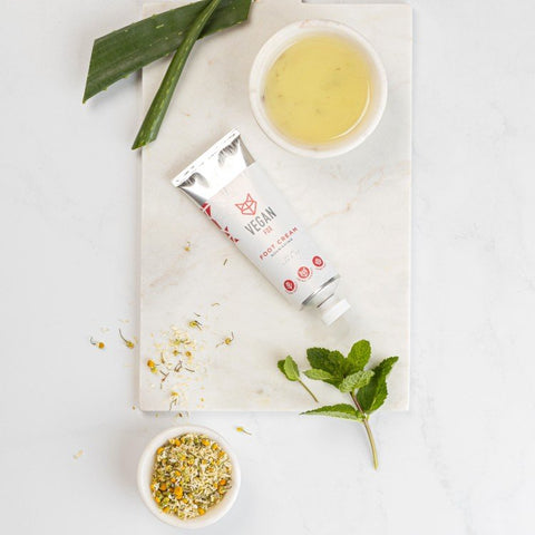 3. Flat lay of Vegan Fox Nourishing Foot Cream with natural ingredients like aloe and chamomile