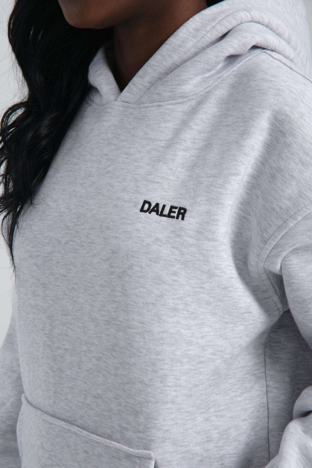3. Close-up of DALER embroidery on grey melange hoodie fabric