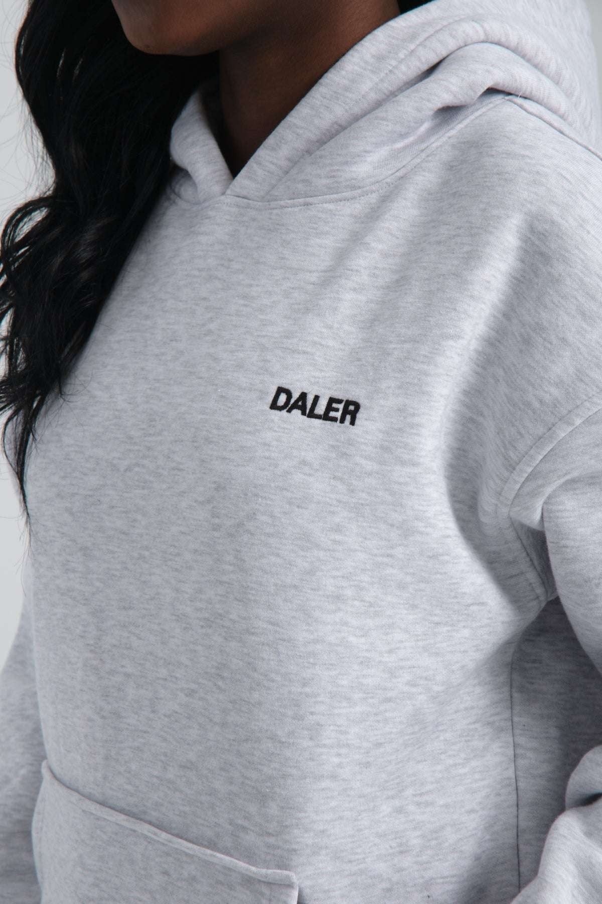 3. Close-up of DALER embroidery on grey melange hoodie fabric