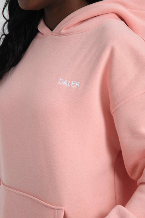 3. Close-up of pink hoodie showing DALER embroidery on chest, highlighting fabric texture