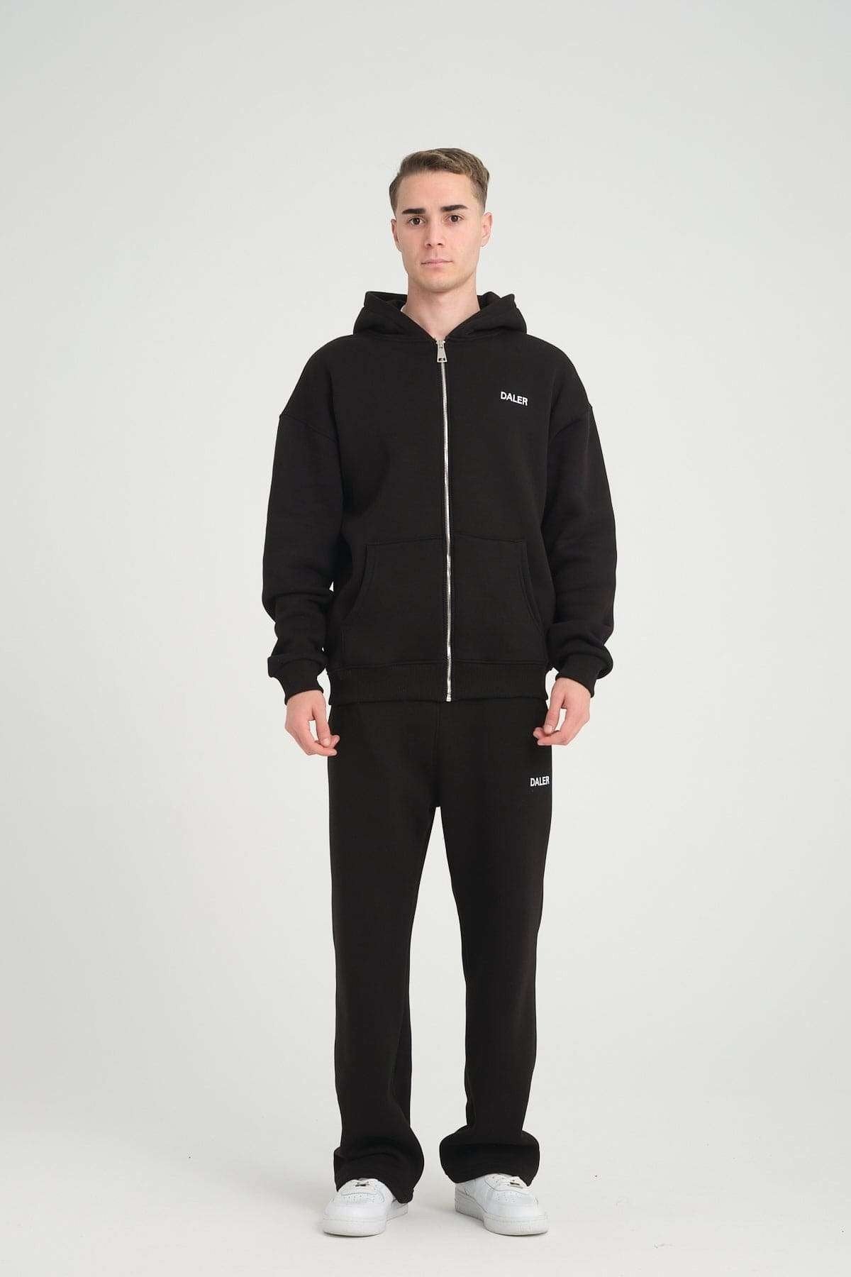 2. Full-body view of man in black DalerClo heavyweight zipper hoodie and matching pants, studio setting
