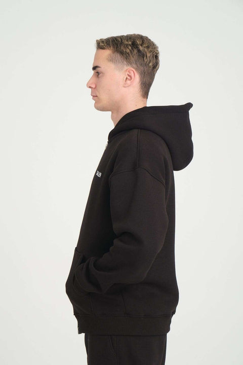 3. Close-up side view of man in black DalerClo heavyweight zipper hoodie, showing hood and pocket detail