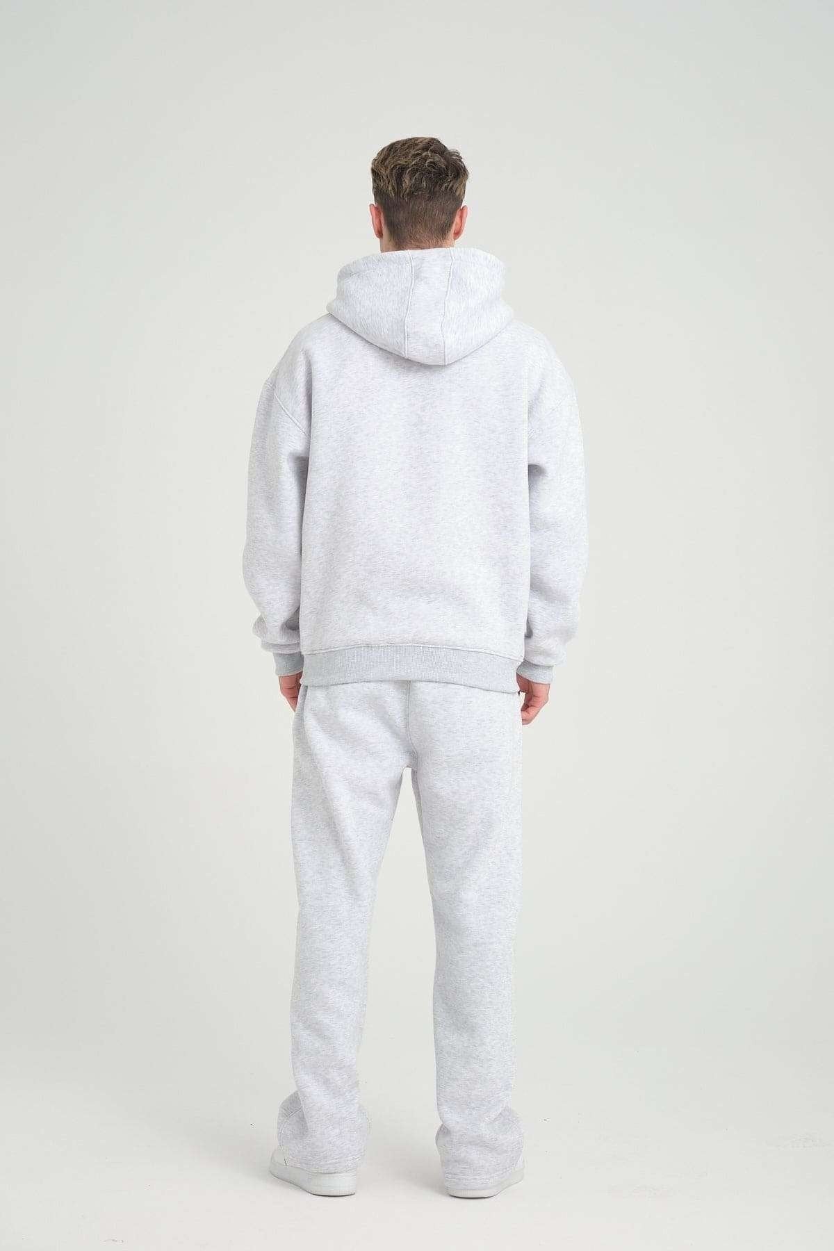 2. Full back view of man in grey melange DalerClo hoodie and matching pants, studio setting