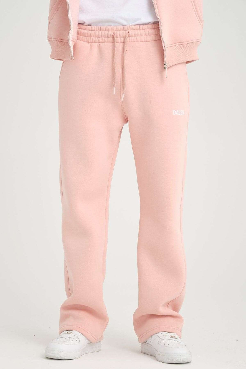 2. Front view of pink jogger pants with open leg design and DALER logo