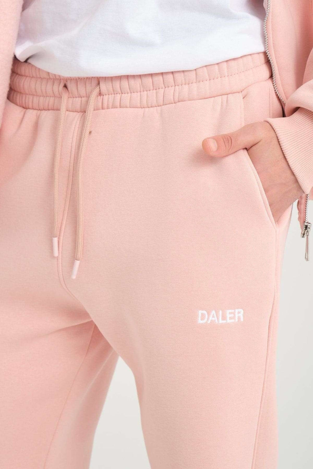 3. Close-up of pink jogger pants waistband with drawstring and DALER embroidery on pocket