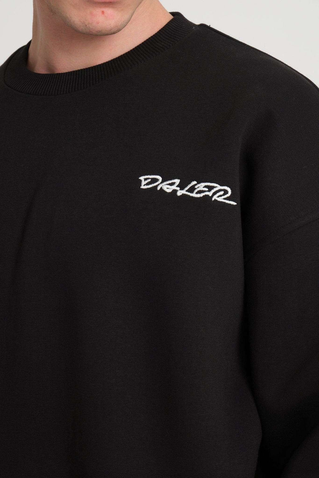 3. Close-up of DalerClo logo embroidered on the chest of black sweatshirt