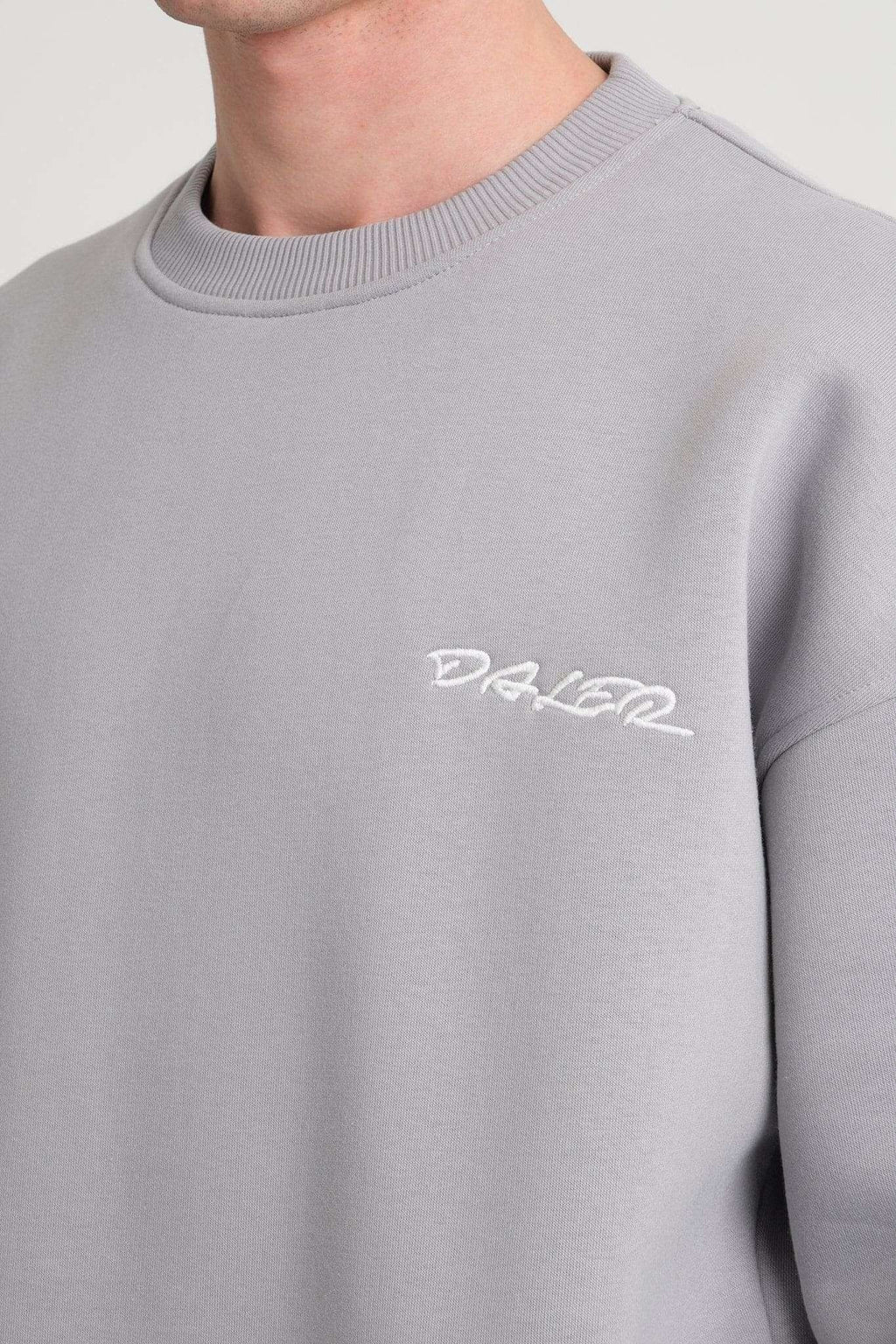 3. Close-up of grey DalerClo sweatshirt chest with white embroidered logo
