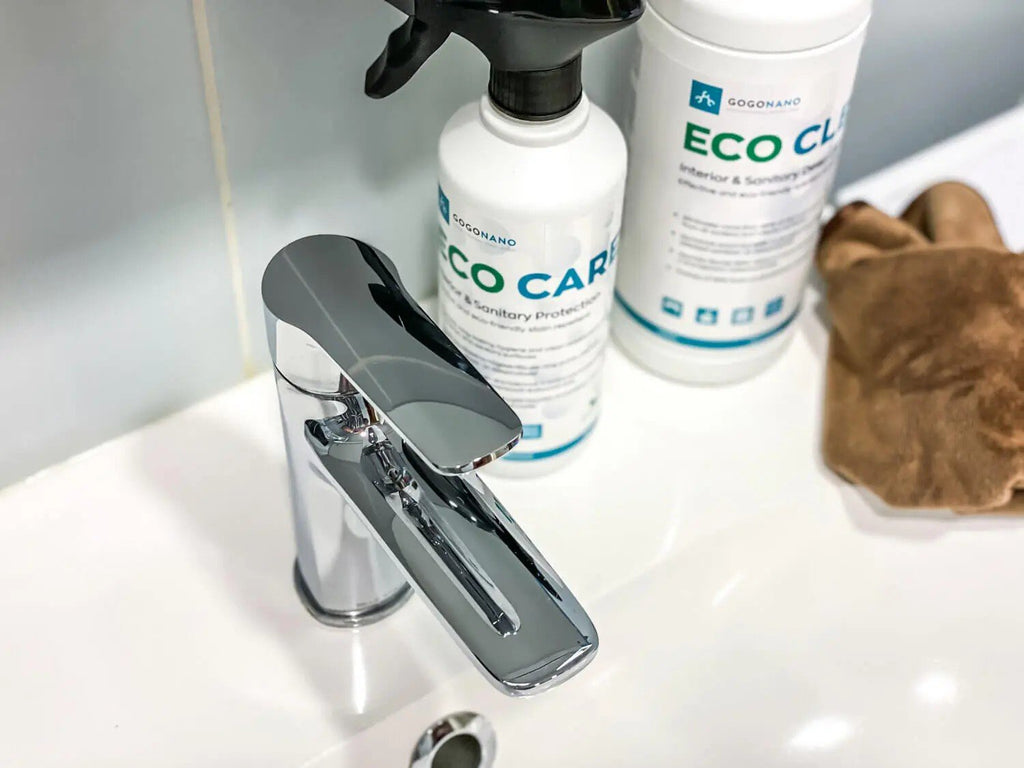 1. GoGoNano EcoClean and EcoCare bottles on bathroom sink with chrome faucet, highlighting eco-friendly cleaning products