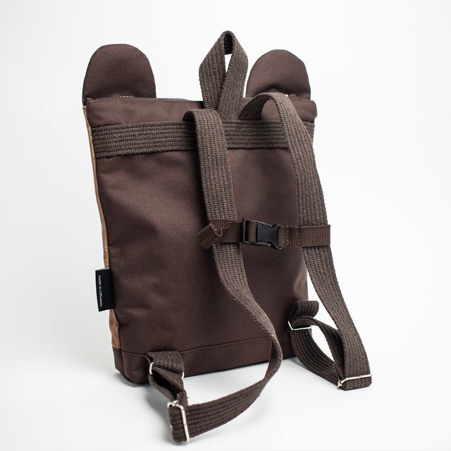 6. Child with Muni bear backpack near vintage car, showcasing adventure-ready design