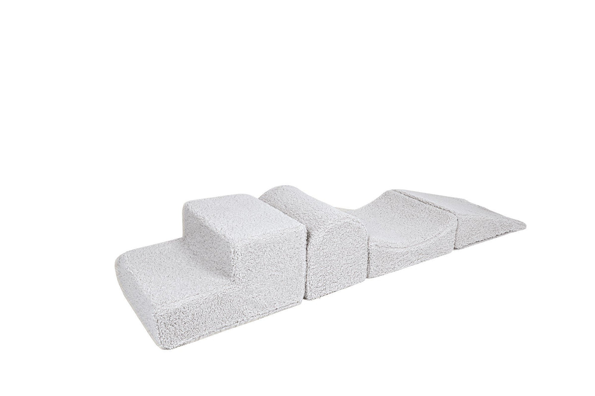 2. Off-white corduroy children's playset with four modular elements resembling Montessori blocks, shown on a white background, highlighting soft texture and removable covers.