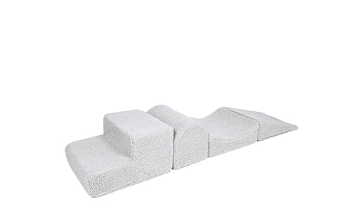 2. Off-white corduroy children's playset with four modular elements resembling Montessori blocks, shown on a white background, highlighting soft texture and removable covers.