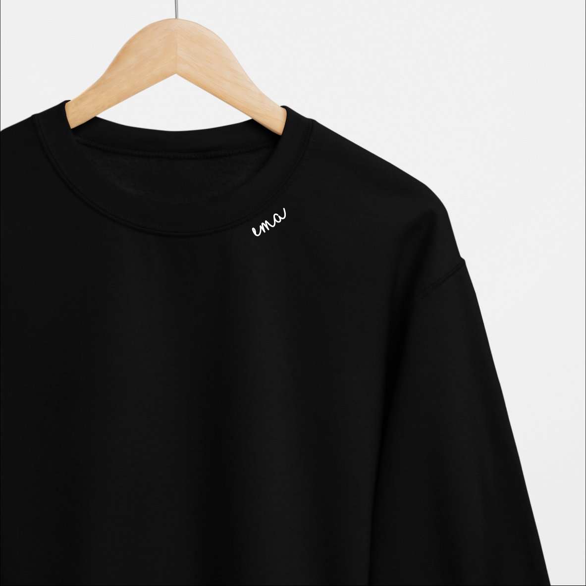 2. Black embroidered collar organic cotton sweatshirt by Beebila on hanger, studio shot