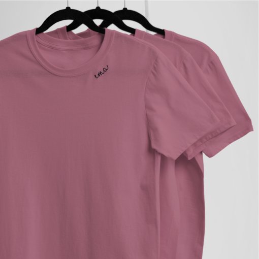 3. Studio shot of pink unisex embroidered collar organic cotton t-shirts on hangers