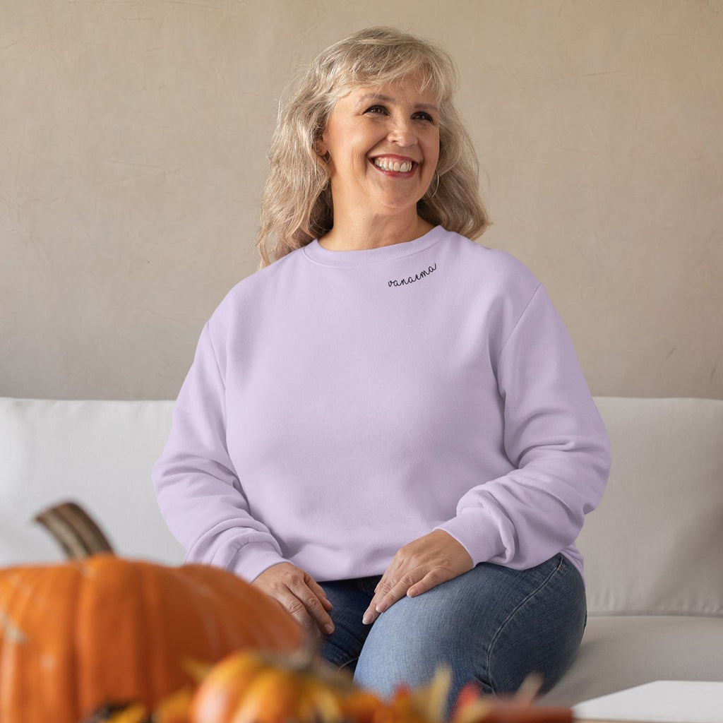1. Woman wearing lilac Beebila 'Vanaema' sweatshirt with embroidered collar, sitting on a sofa