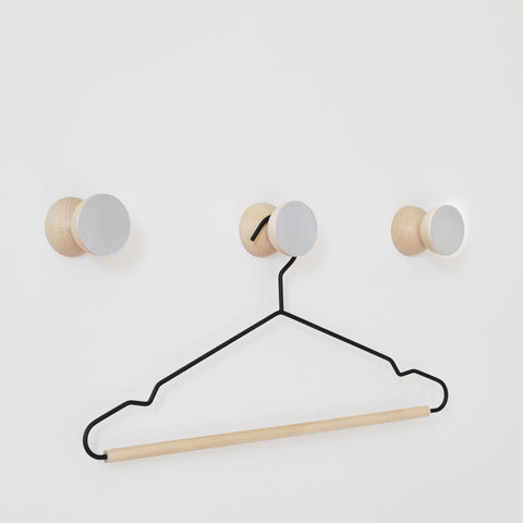 2. Studio shot of 5mm Paper Beech Wood & Aluminium Wall Hooks with a hanger, showcasing versatility