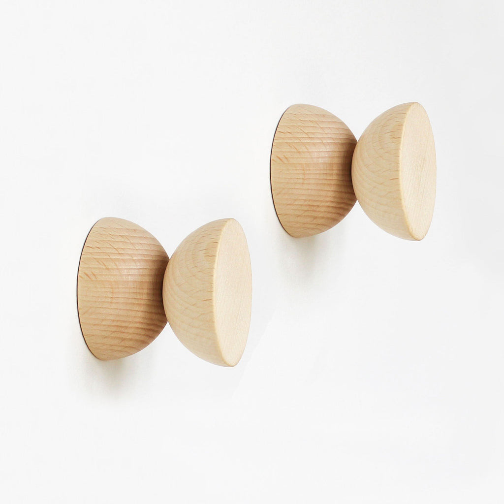 5. Studio image of two beech wood wall hooks by 5mm Paper mounted on a white wall